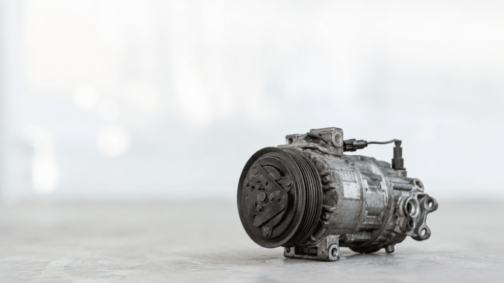 Car air conditioning compressor failure with mechanic checking the climate control