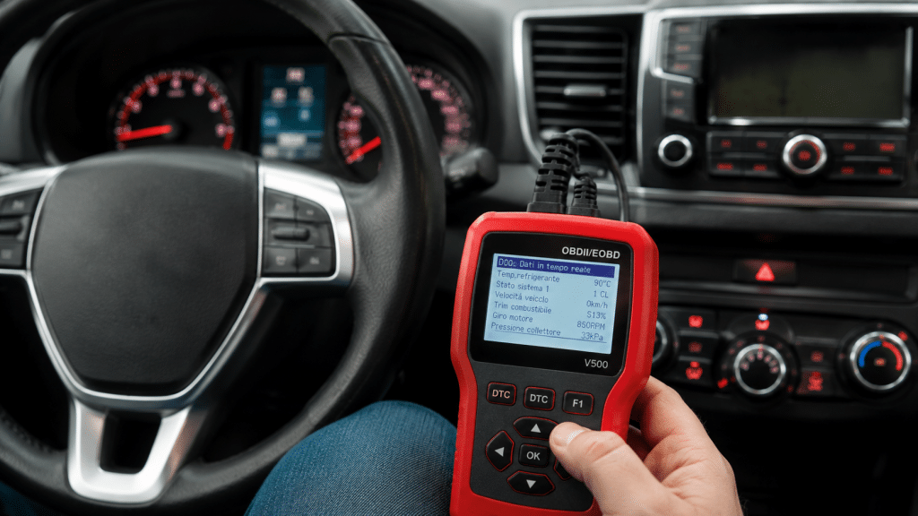 OBD diagnostic scanner connected to the car to check for radiator fan errors