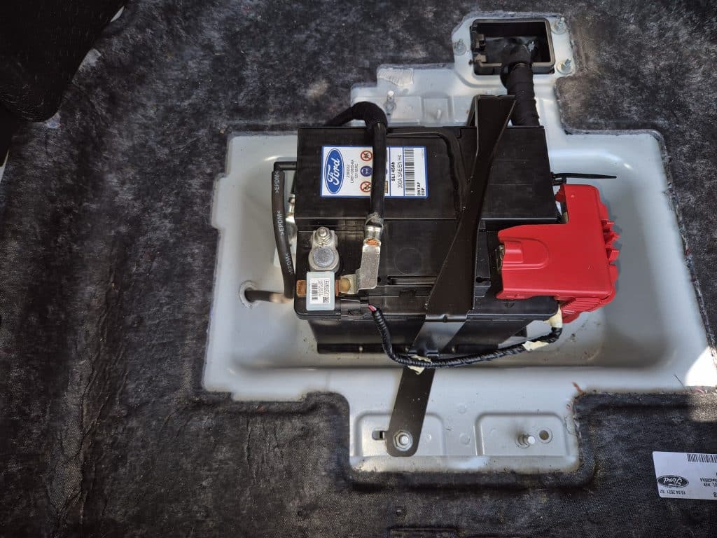 Ford Kuga PHEV trunk with access to the 12V battery compartment.
