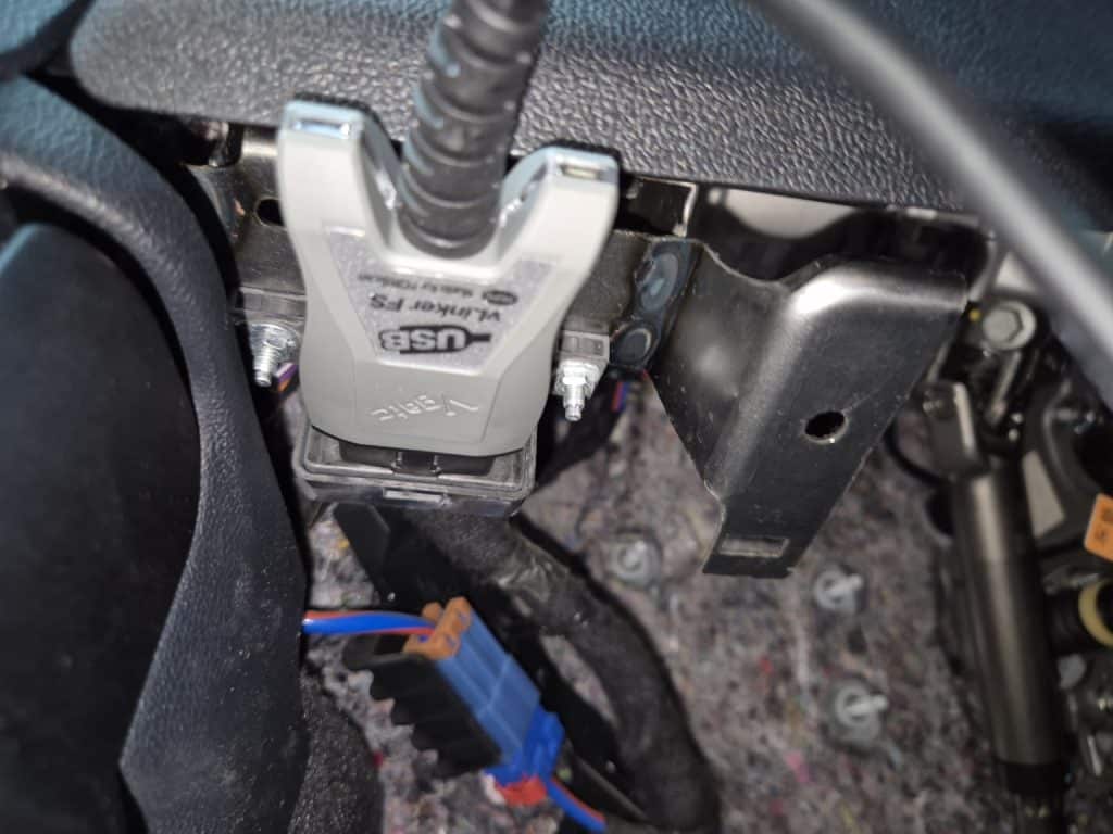 Vgate vLinker OBD2 scanner connected to the OBD2 diagnostic port of a Ford Kuga PHEV for diagnosis with FORScan