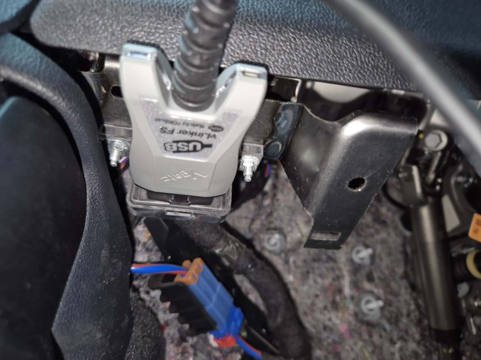 Vgate vLinker OBD2 scanner connected to the OBD2 diagnostic port of a Ford Kuga PHEV for diagnosis with FORScan